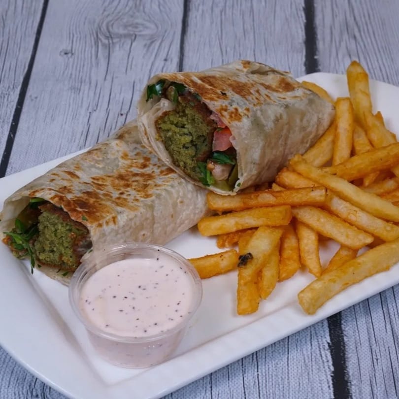 Falafel gyros wrap, fries, and a side of sauce on a white plate from Cairos Gyros Tempe.